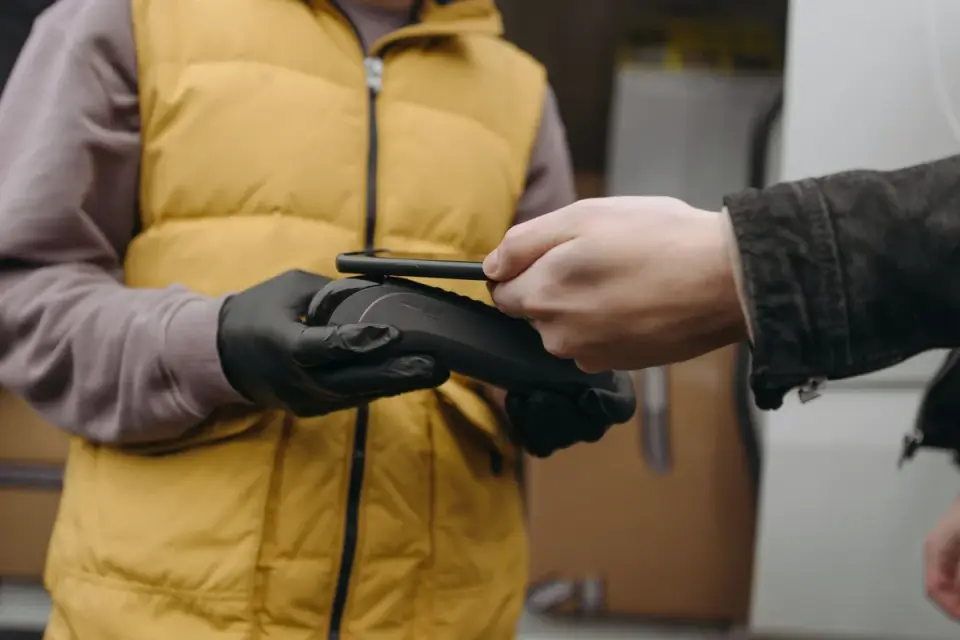 A veterinarian scanning a dog&#x27;s shoulder area with a handheld microchip reader