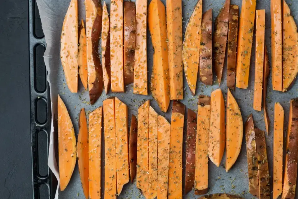 Raw sweet potato slices next to cooked, softened sweet potato cubes